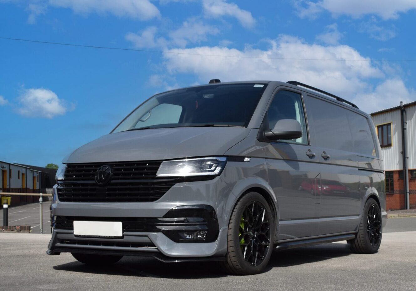 Gray van parked on an industrial street.